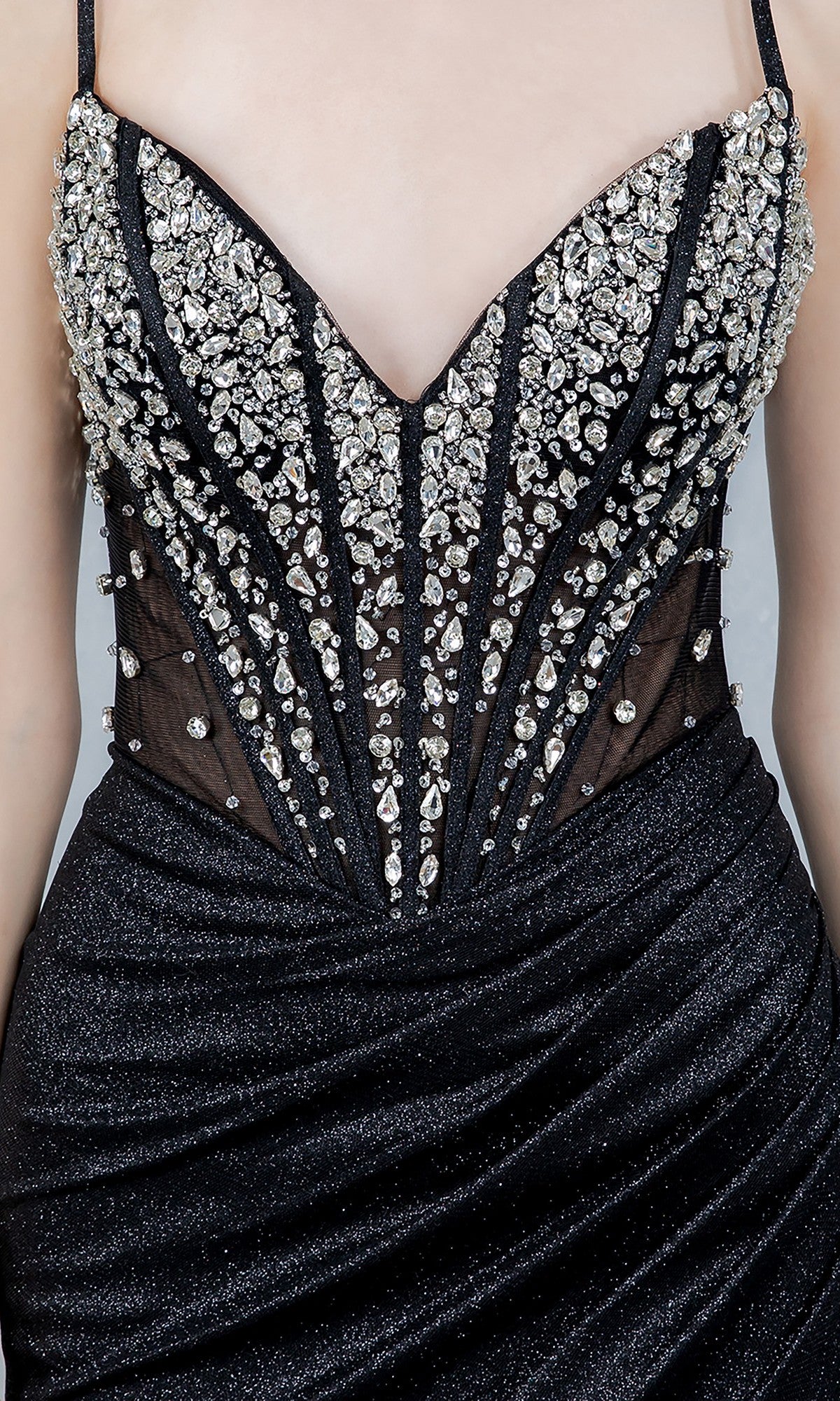 Close-up of the Cinderella Couture 8562J: a black, strapless glitter prom dress with a sheer jeweled corset bodice decorated with silver rhinestones and intricate beadwork.